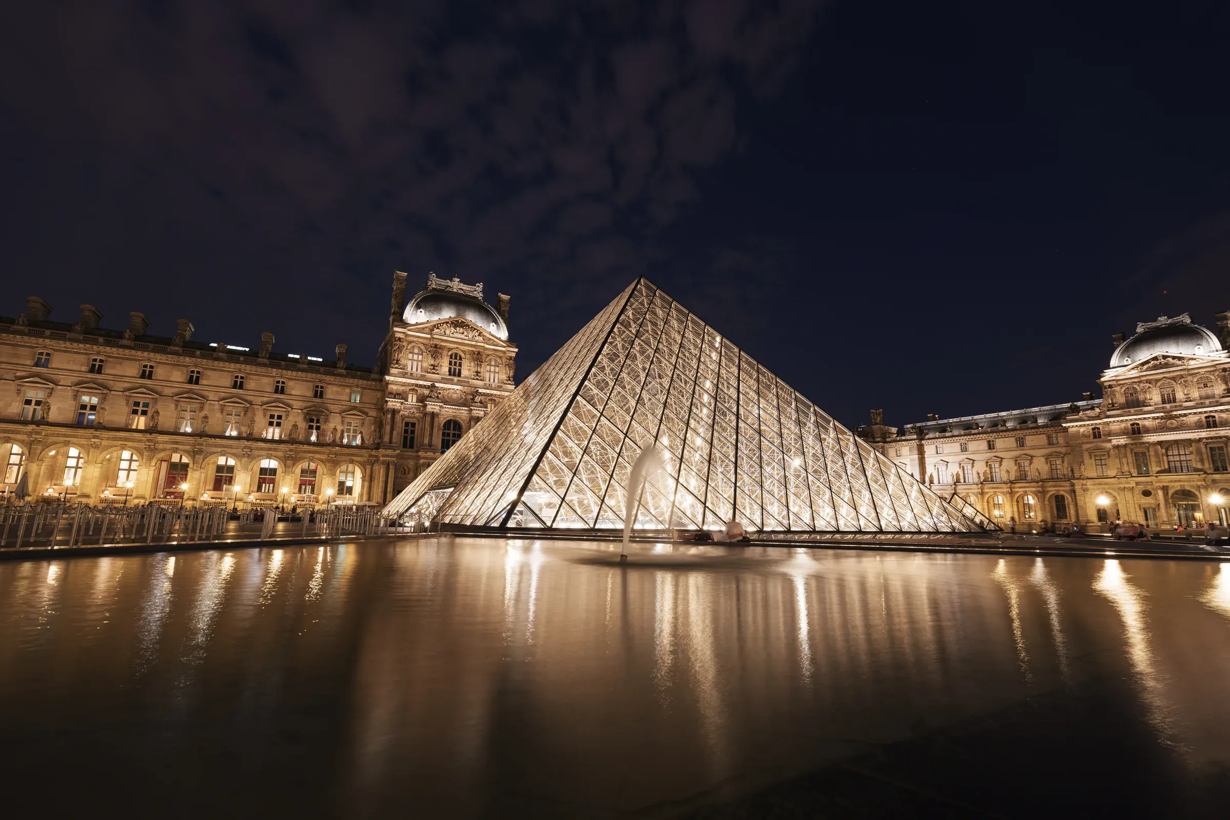 The illuminated Louvre pyramid at night